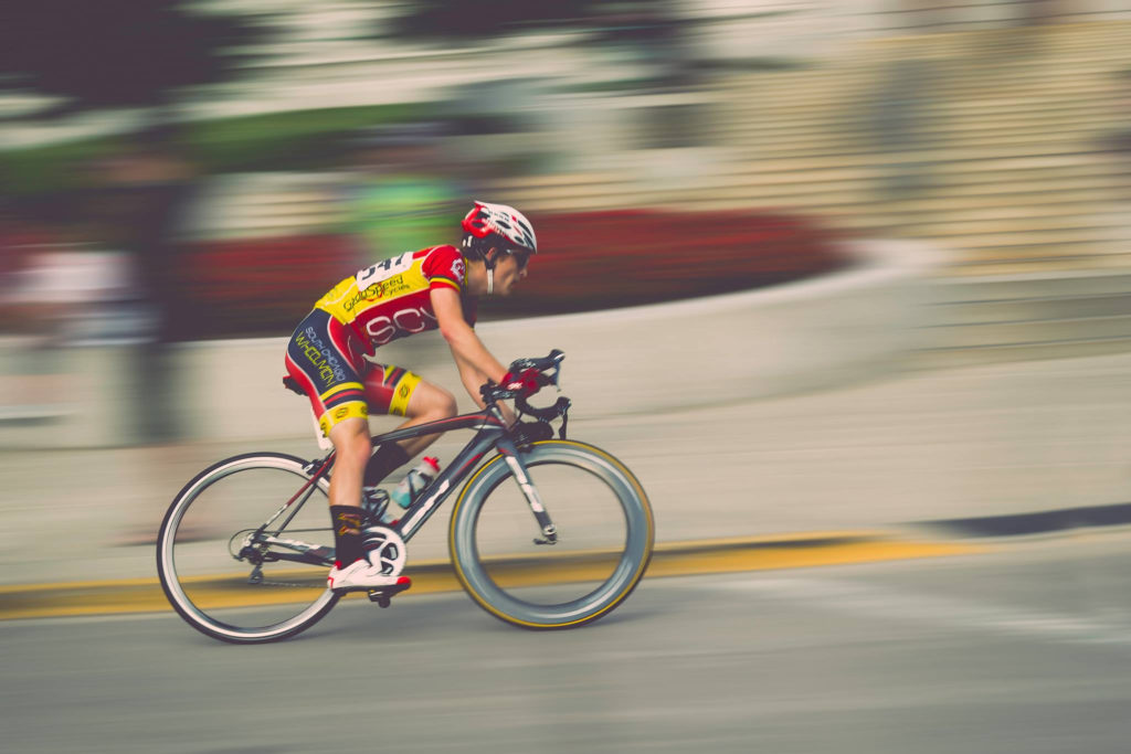 Man riding bike fast to represent acceleration 