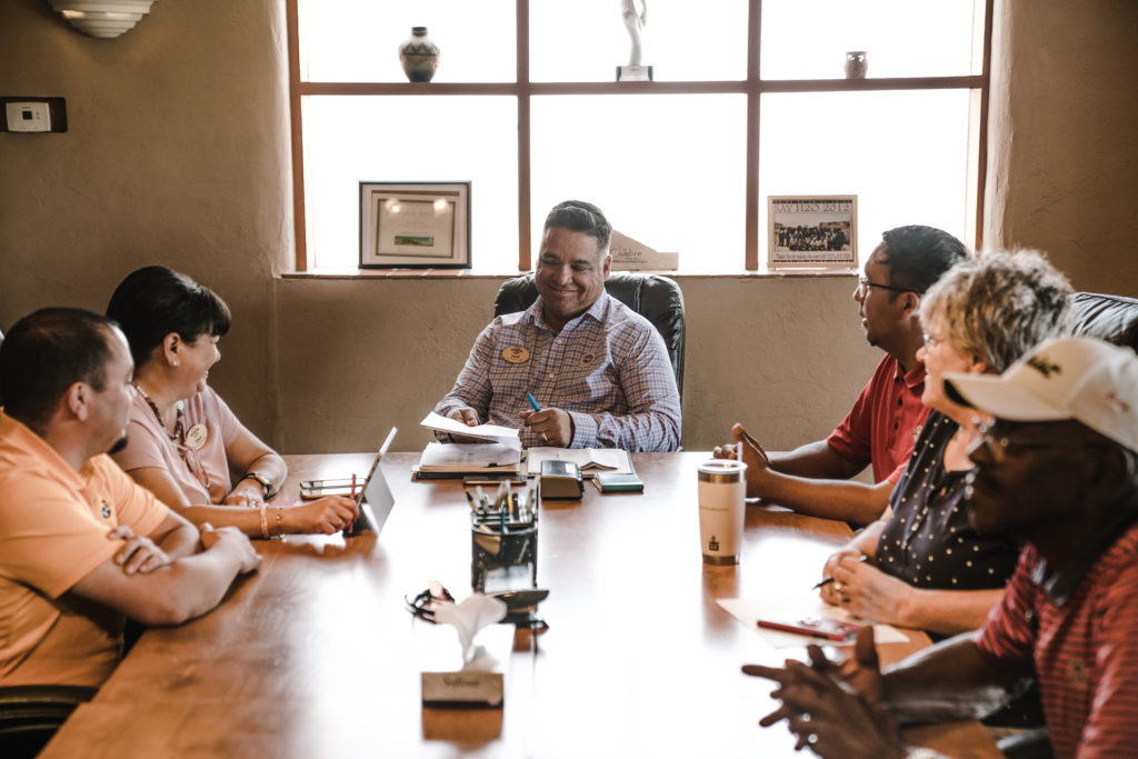 People around table in traditional work environment