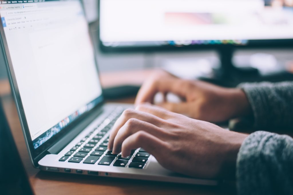 hands typing on the computer